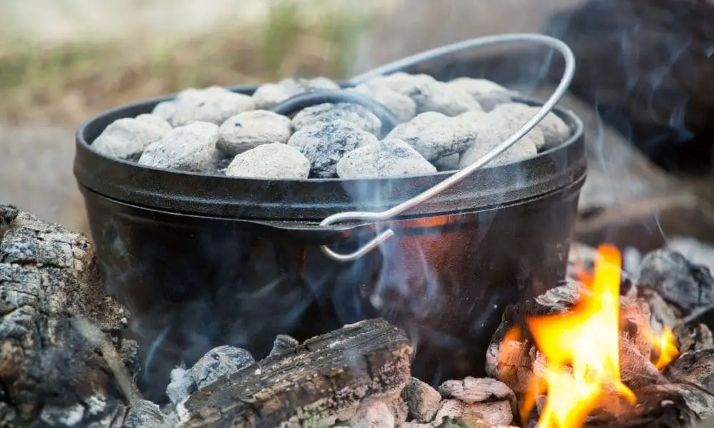 dutch oven over coals at a campsite