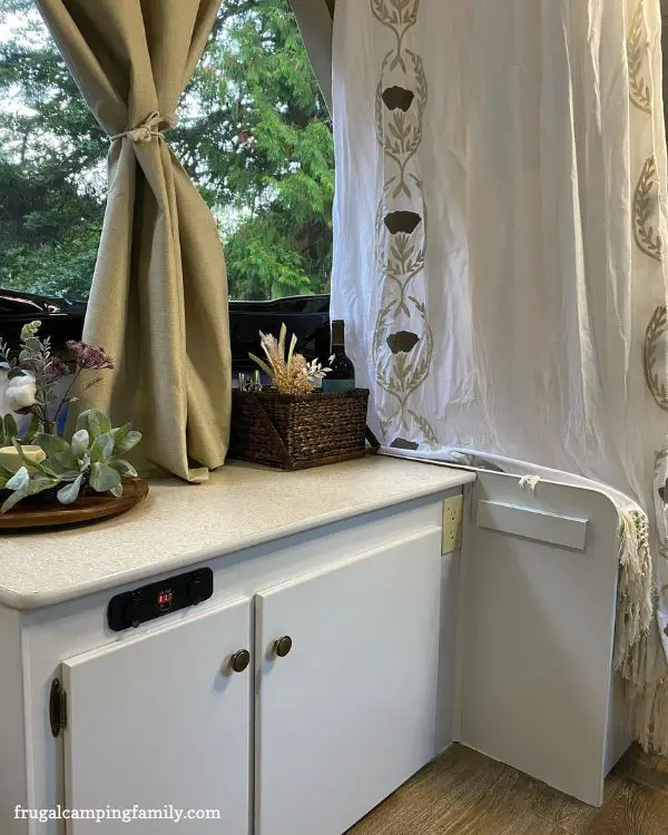 tan curtain and white shower curtain in popup camper reno