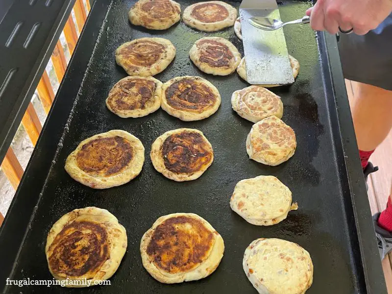 Cinnamon roll pancakes on the griddle