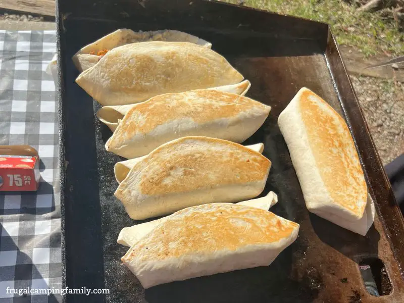 browned breakfast burrito on a griddle