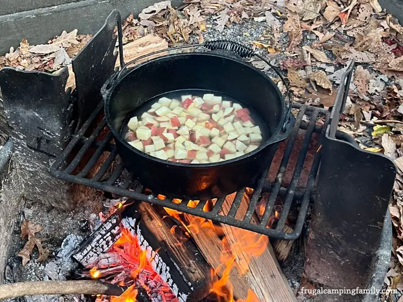 potatoes cooking in dutch oven over campfire