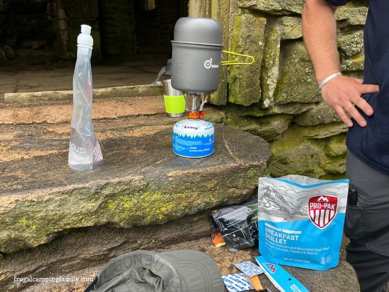 cooking a meal over hiking stove